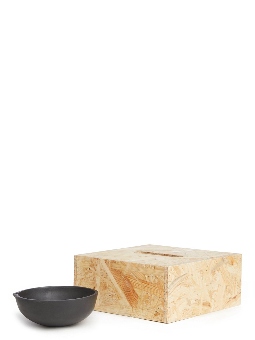 RICK OWENS BOWL HAS A ROUND SHAPE AND FEATURES A SMALL TRIANGLE DETAIL AND POLISHED SURFACE.